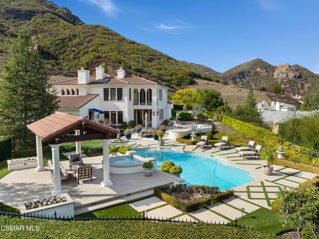 view of pool with a mountain view, a gazebo, and a patio