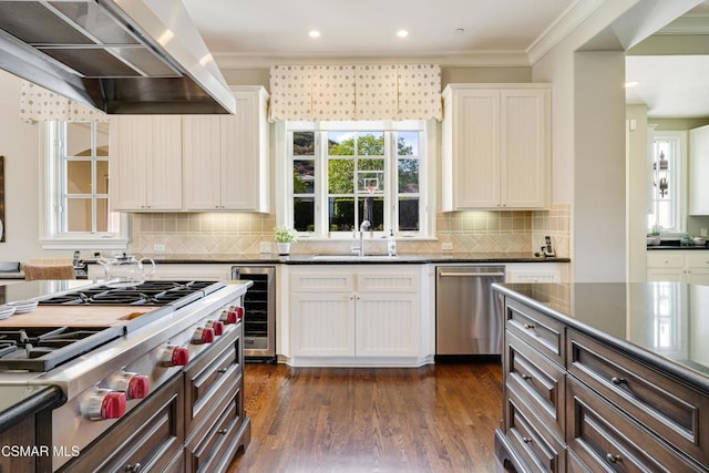 kitchen featuring sink, white cabinetry, stainless steel appliances, wine cooler, and extractor fan