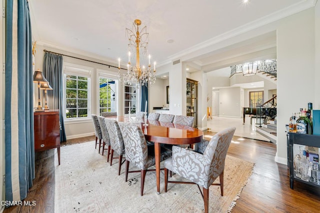 dining space featuring ornamental molding, a chandelier, and hardwood / wood-style floors