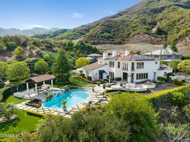 exterior space featuring a gazebo, a mountain view, and a patio