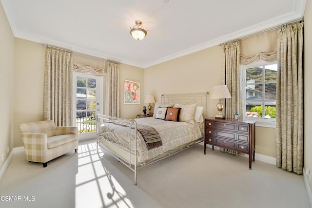 carpeted bedroom featuring crown molding and access to outside