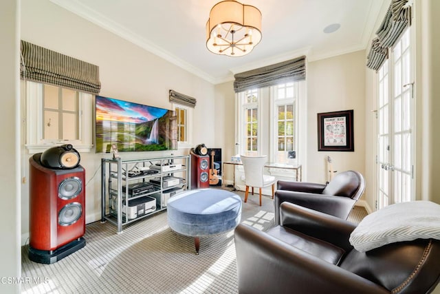 sitting room featuring carpet floors, crown molding, a wealth of natural light, and a chandelier