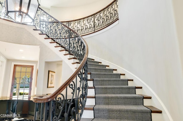 staircase featuring a high ceiling