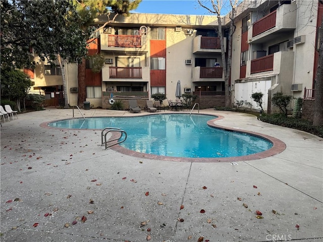 view of swimming pool with a patio