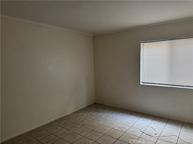 unfurnished room featuring light tile patterned floors and crown molding