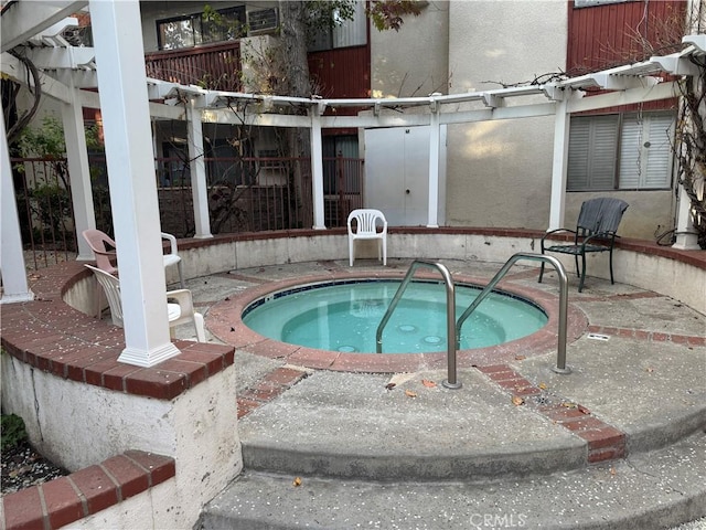 view of pool featuring an in ground hot tub, a pergola, and a patio