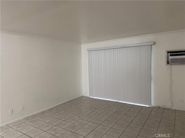 spare room with a wall mounted air conditioner and ornamental molding