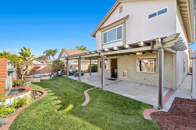 back of property with a yard, a hot tub, and a patio