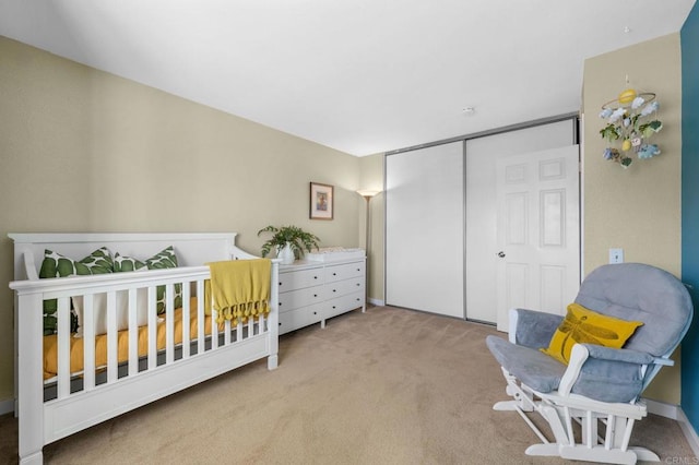 carpeted bedroom with a nursery area and a closet