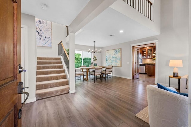 foyer with hardwood / wood-style flooring and a notable chandelier