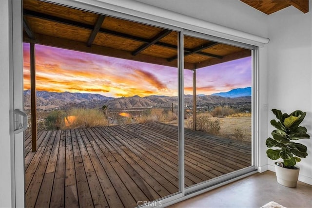 doorway featuring concrete flooring and a mountain view