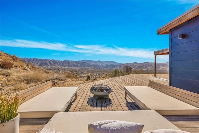 exterior space featuring a mountain view and a fire pit