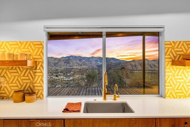 interior details featuring a mountain view and sink