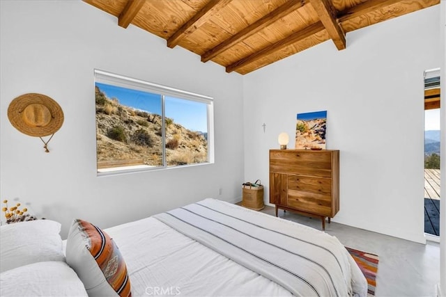 bedroom with concrete flooring, vaulted ceiling with beams, and wooden ceiling