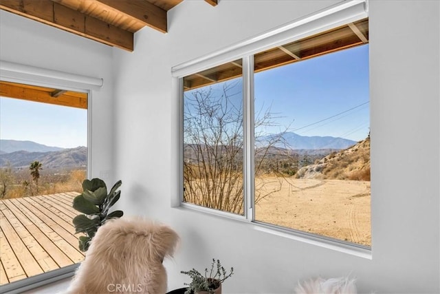 interior space featuring a mountain view and beam ceiling