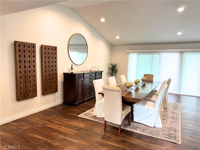 dining room featuring dark wood-type flooring and vaulted ceiling