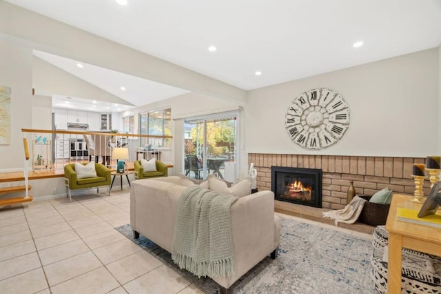 tiled living room featuring lofted ceiling and a fireplace