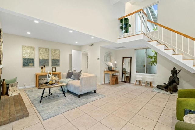 tiled living room featuring a high ceiling