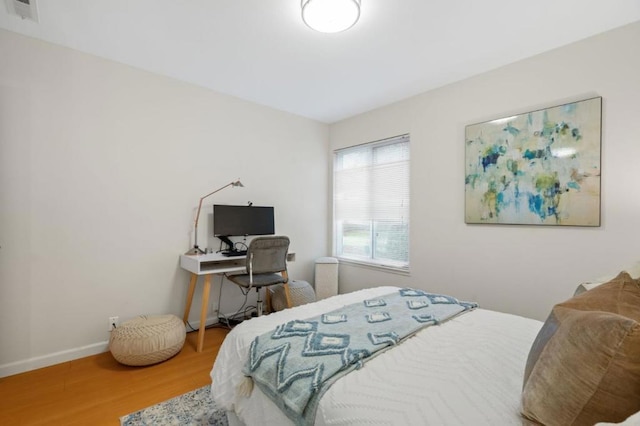 bedroom with hardwood / wood-style floors