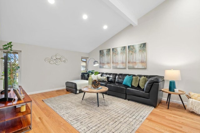 living room with beamed ceiling, high vaulted ceiling, and hardwood / wood-style flooring