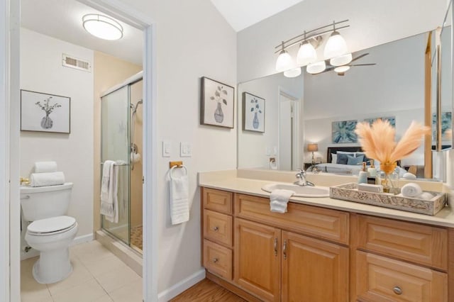 bathroom with vanity, toilet, tile patterned floors, and walk in shower