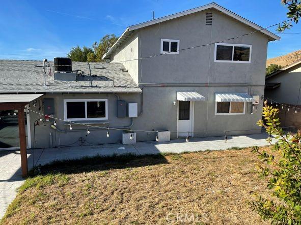 rear view of house featuring a lawn