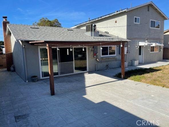 back of property with a patio area