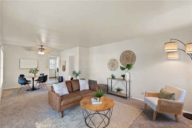 carpeted living room featuring ceiling fan