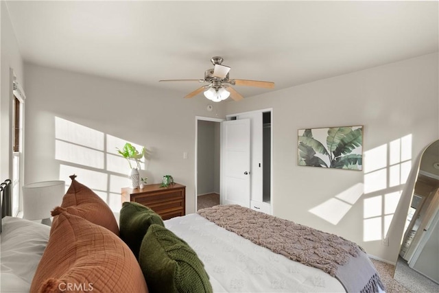 bedroom with carpet, ceiling fan, and a closet