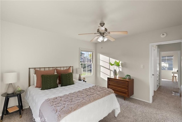 bedroom featuring light colored carpet and ceiling fan