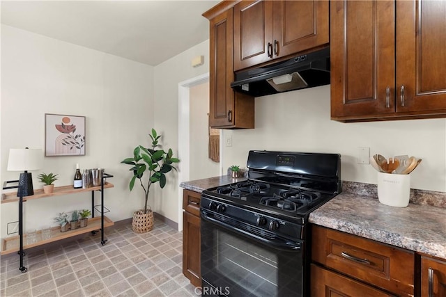 kitchen featuring dark stone counters and black gas range