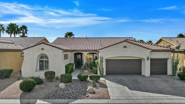 mediterranean / spanish home with a garage