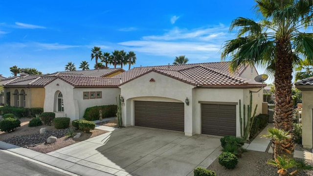 mediterranean / spanish home with a garage