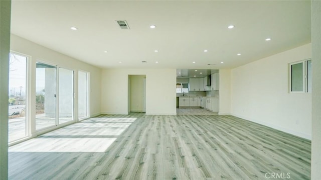 unfurnished living room with light wood-type flooring