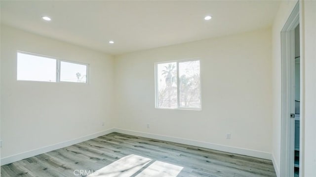 unfurnished room with light hardwood / wood-style flooring and a healthy amount of sunlight