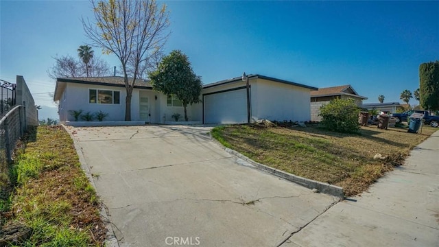 ranch-style house with a garage and a front yard