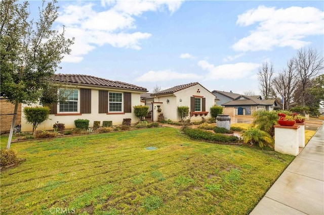 mediterranean / spanish-style home featuring a front lawn