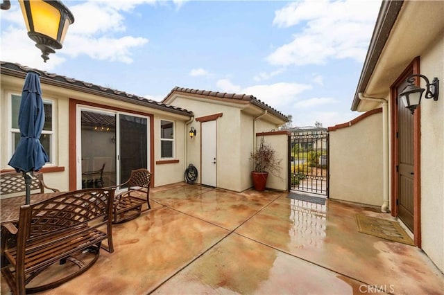 view of patio featuring a gate