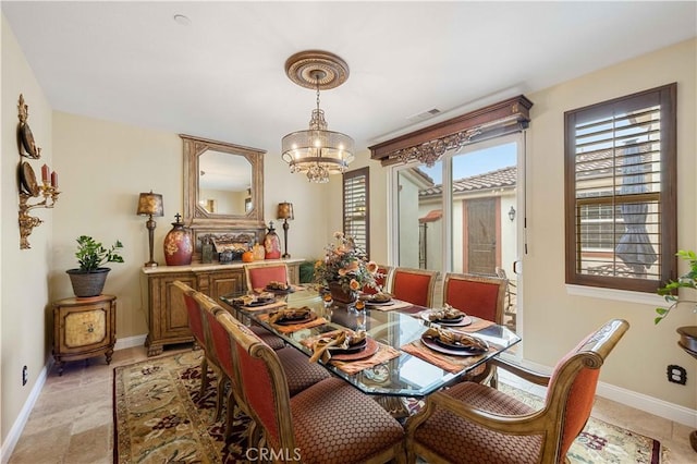 dining room with visible vents, a notable chandelier, and baseboards