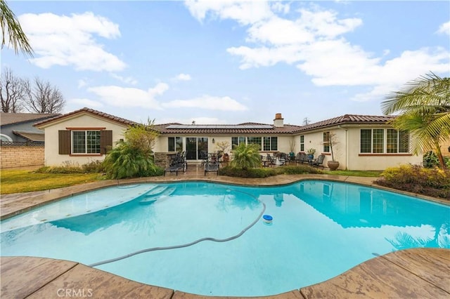 pool featuring a patio area and fence