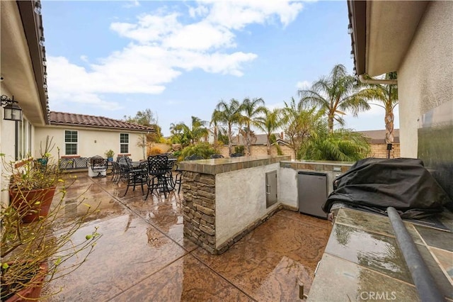 view of patio / terrace with area for grilling, exterior kitchen, and outdoor dining space