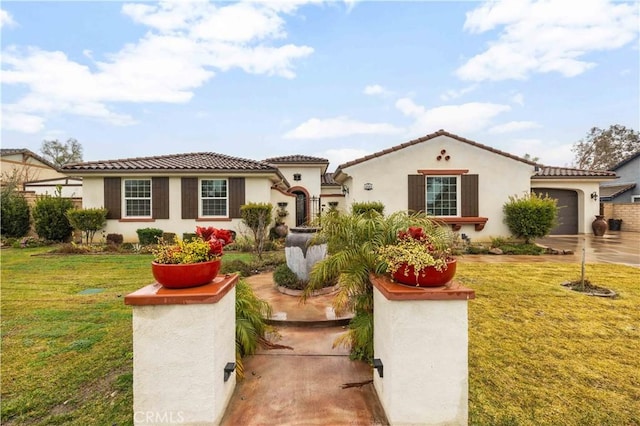 mediterranean / spanish house with a garage and a front lawn