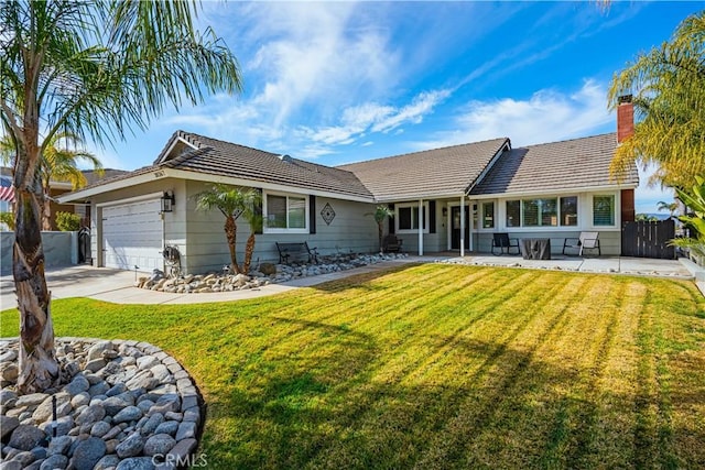 view of front of house with a garage and a front lawn