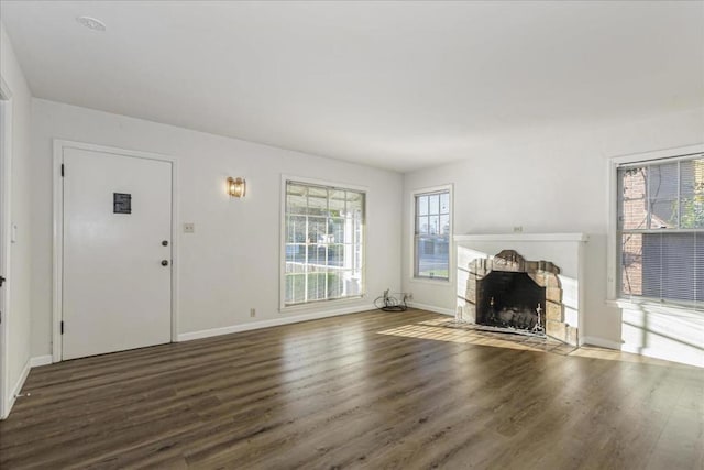 unfurnished living room featuring dark hardwood / wood-style flooring and a fireplace