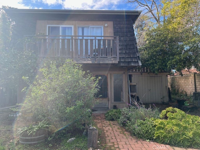 back of house with a balcony