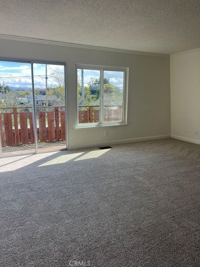 unfurnished room featuring baseboards, carpet floors, a textured ceiling, and crown molding