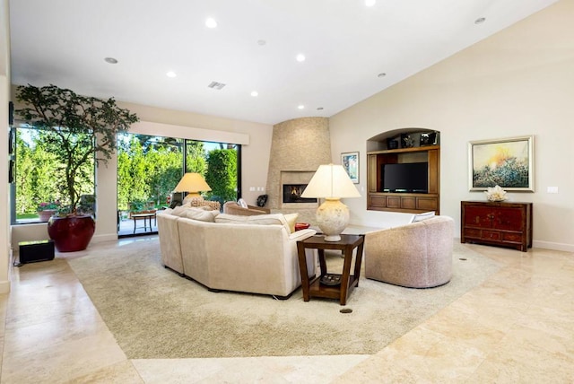 living room featuring built in shelves and a fireplace