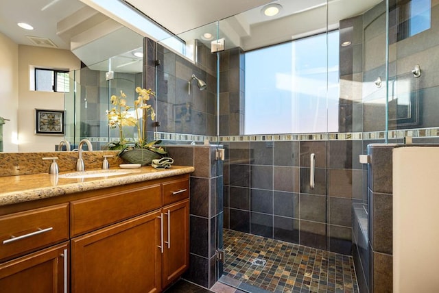 bathroom with vanity and a shower with shower door