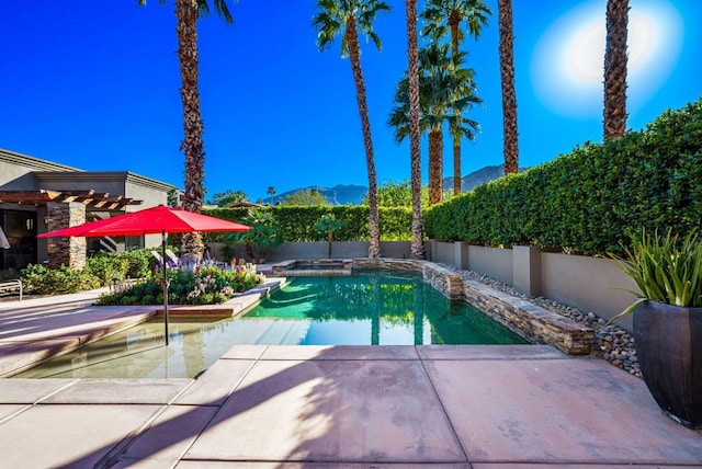 view of swimming pool featuring a mountain view and a patio area