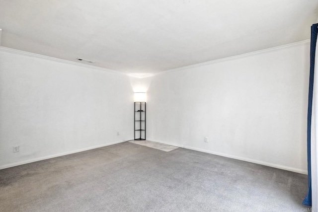 unfurnished room featuring crown molding and carpet flooring